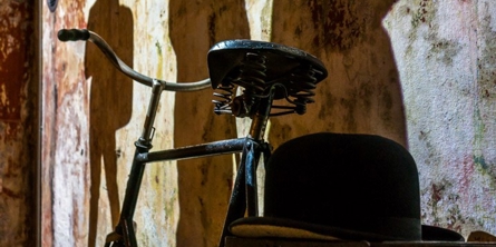 Udstillingsrum med gammeldags cykel og projektion på væg